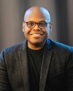 Board member, Terrance Stevenson, a smiling black man with glasses